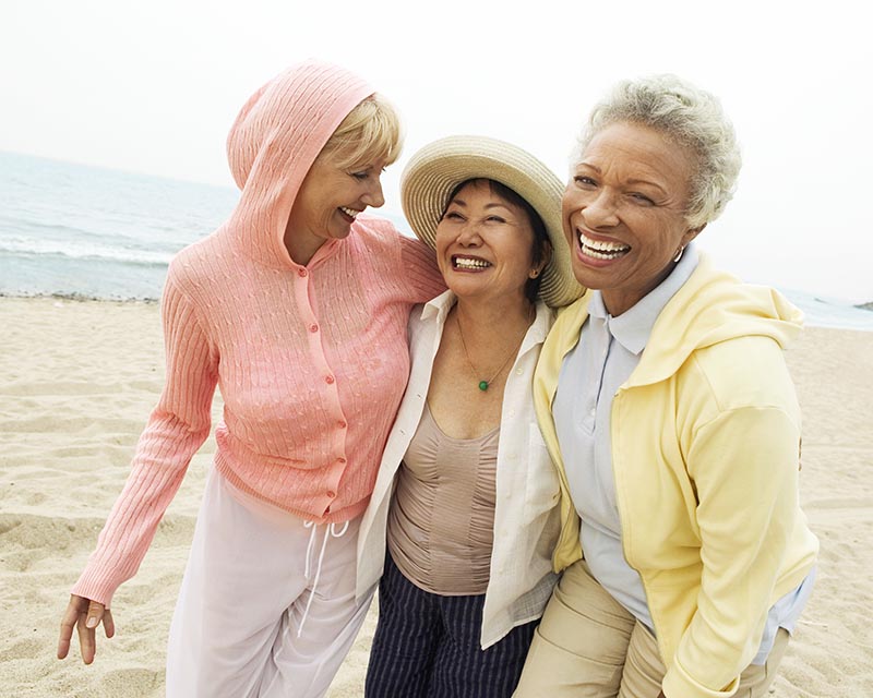 happy friends enjoying beach